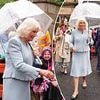 Queen Camilla refuses to let the rainy weather dampen her spirits as she visits 'the most beautiful racecourse'