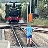 Heart-stopping moment young boy stands his ground in deadly game of chicken with oncoming steam train