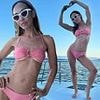 Myleene Klass shows off her impressive abs in a skimpy pink bikini as she enjoys a boat trip in Greece