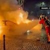 Car ploughs into crowd of football fans after PSG's victory over Arsenal as violence breaks out on the streets of Paris