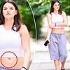 Suri Cruise, 19, debuts a belly button piercing when in a crop top... after finishing her first year of college