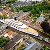 Not a latte room for error! £150million superyacht owned by ex-Starbucks CEO squeezes through Dutch canal with inches to spare
