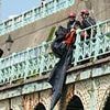 Moment more than a dozen council officers abseiled down wall to clear man's homeless camp on Brighton's seafront
