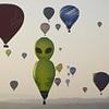 Up, up and away! Skies above Bristol fill with dinosaurs, aliens and cows for annual balloon festival