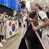 Moment South Korean Tottenham fan bursts into tears after meeting James Maddison - as captain Son Heung-min and team-mates receive rapturous welcome