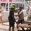Shocking moment Spanish cop slaps tourist 'who swore at him after complaining about police treatment of African beach sellers' in Marbella