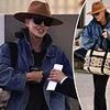 Hollywood A-lister goes incognito in dark sunglasses and fedora as she jets out of Sydney