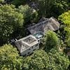 Eerie £3m mansion with sprawling treehouse in back garden is patrolled 24/7 by security dog team... despite being abandoned for years