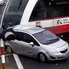 Moment train ploughs into car after driver smashes through barrier at level crossing and stops on tracks