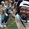 NFL legend Marshawn Lynch throws an elbow at a player while working as a photographer at Seahawks game