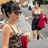 Lily Allen shows off the results of her boob job in a sheer bralet and matching shorts as she poses for racy snaps during a day out in London
