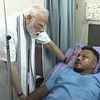 British Air India plane crash survivor describes how the jet split in two and he was 'ejected' before it exploded - as he is visited by Indian PM