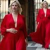 Pregnant Pixie Lott showcases her blossoming baby bump in a plunging red gown as she steps out in London - just weeks before her due date