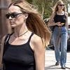 Braless Margot Robbie steps out wearing dark sunglasses after living it up in Ibiza and Glastonbury