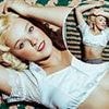 Singer debuts bold new look that leaves fans gobsmacked as she channels Hollywood icon in 1930s pin-up style blonde wig and frilly crop top... but can you guess who it is?
