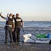 Calais police pose for a selfie after they slash people smugglers' dinghy... before letting the gang saunter away
