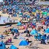A tale of two beaches: Crowds rush to enjoy the sands in glorious sunshine... while others are turned away at shut-off seasides