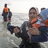 French police watch on hopelessly while huge groups of migrants - many carrying small children - set sail for Britain as Labour's one-in, one-out policy shows no sign of deterring illegal arrivals