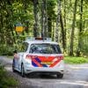 Spookrijder in Tilburg opgepakt na wilde achtervolging, politieauto over de kop