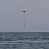 Incredible footage captures moment drowning young girl caught in rip current is saved by fisherman's drone