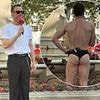 Olly Murs puts on a VERY cheeky display as he strips off to his underwear in London's Leicester Square for hilarious stunt