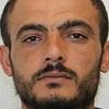 Police hunting for Syrian national, 35, after five football fans were stabbed outside a German bar in 'planned' attack