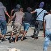 Hell in Haiti: How criminals have turned nation into a warzone that has spiralled into complete collapse, kids are raped or forced to become gang 'soldiers' and locals 'pray we're not next'