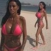 Katie Price flaunts her assets in a hot pink bikini on the beach in Dubai just one day after British Airways cancelled flights there amid Middle East strikes