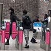 Moment staff on London's 'lawless' Tube appear to ignore two fare dodgers who shamelessly push their way through barriers next to where they are standing