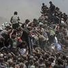 Videos 'show hundreds of frantic Gazans swarming aid trucks' as Israel pauses fighting amid war of words over 'starvation' and who is to blame