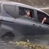 Heartstopping moment mother and child are trapped in a sinking car after they veer off road and are plunged into a roadside ditch