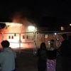 Chaos outside Epping's migrant hotel as protest videos emerge of lit flares 'being thrown' from windows whilst 'terrified' residents claim 'fireworks were aimed at building' as police confirm arrest
