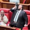 Moment Australian politician signs off career by pouring beer into his shoe and drinking it