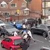 Terrifying moment thug pulls out machete during 20-person brawl on residential street