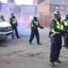 Bottles and smoke flares thrown in hotel protest