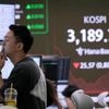 Asian shares are mixed after Nvidia nudges Nasdaq to a record, while other US stocks slump