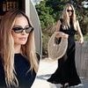 Margot Robbie carries a $1,090 beach bag and looks glamorous in a sheer black dress as she celebrates her 35th birthday in party town Ibiza