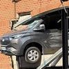 Pedestrians rushed to hospital after being hit by falling rubble when van ploughed through wall and was left dangling from car park building