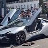 Moment reckless driver sparks street brawl after crashing her £106,000 BMW i8 into parked car on busy London street