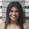 Jealous ex-girlfriend smiles in mugshot after arrest for trashing former flame's car